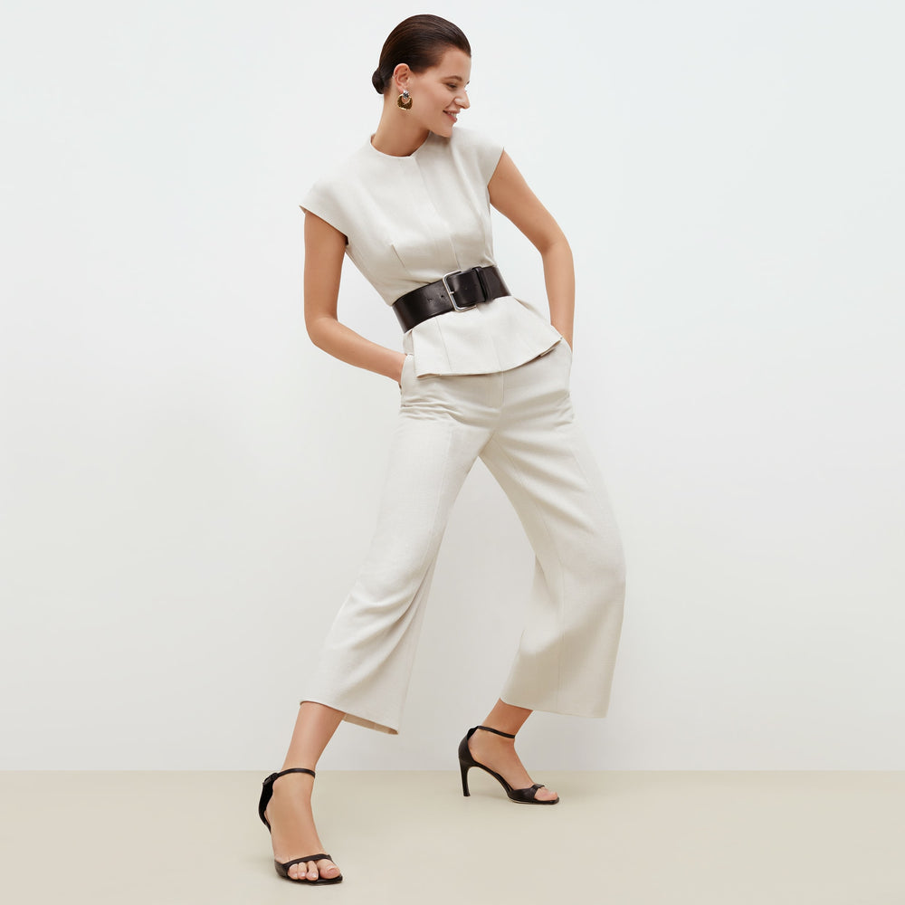Front image of a woman standing wearing the lulu jacket in textured suiting in magnolia