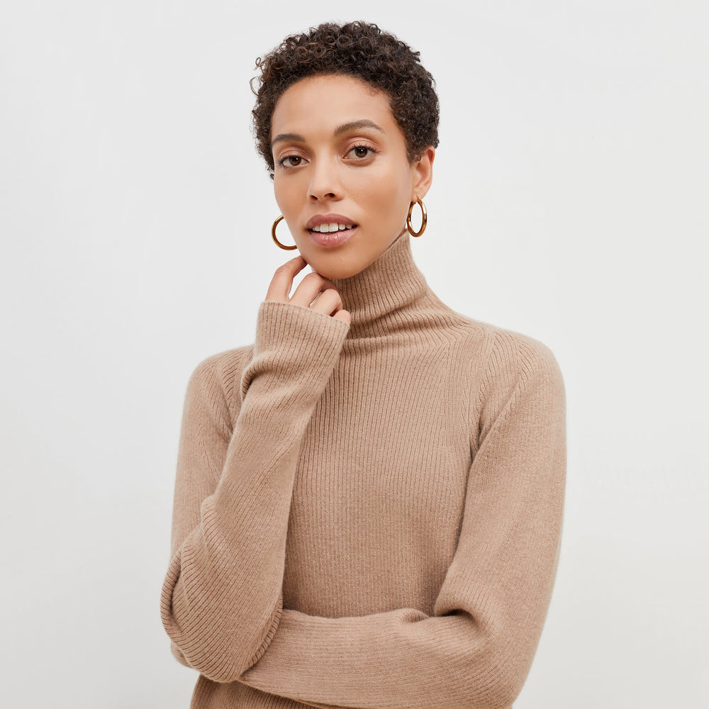front image of a woman wearing the mckenzie sweater in deep flax