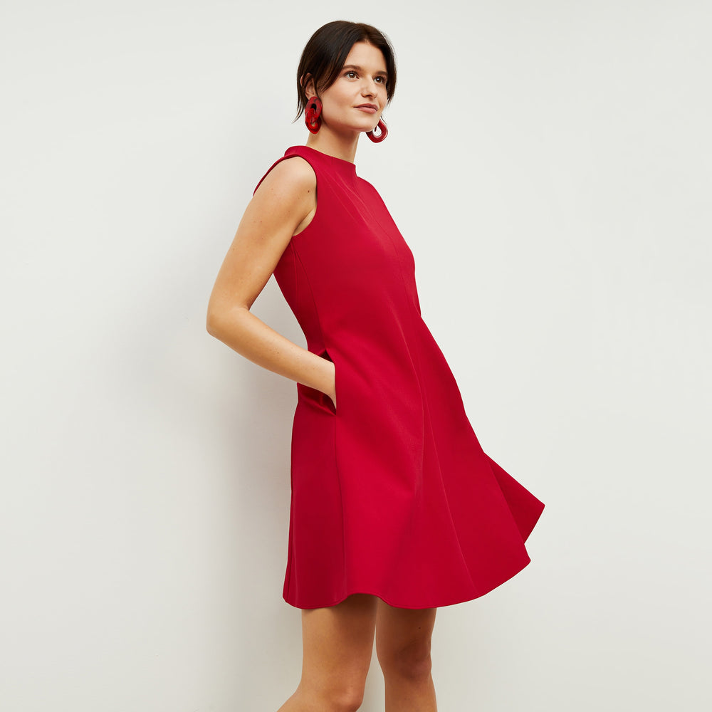 Side image of a woman standing wearing the Malala Dress—Recycled WonderTex in Rhubarb