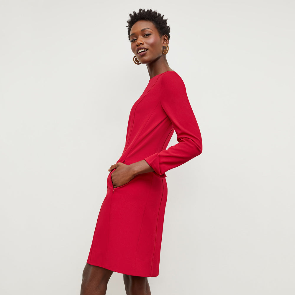 Side image of a woman standing wearing the Novara Dress—Recycled WonderTex in Rhubarb