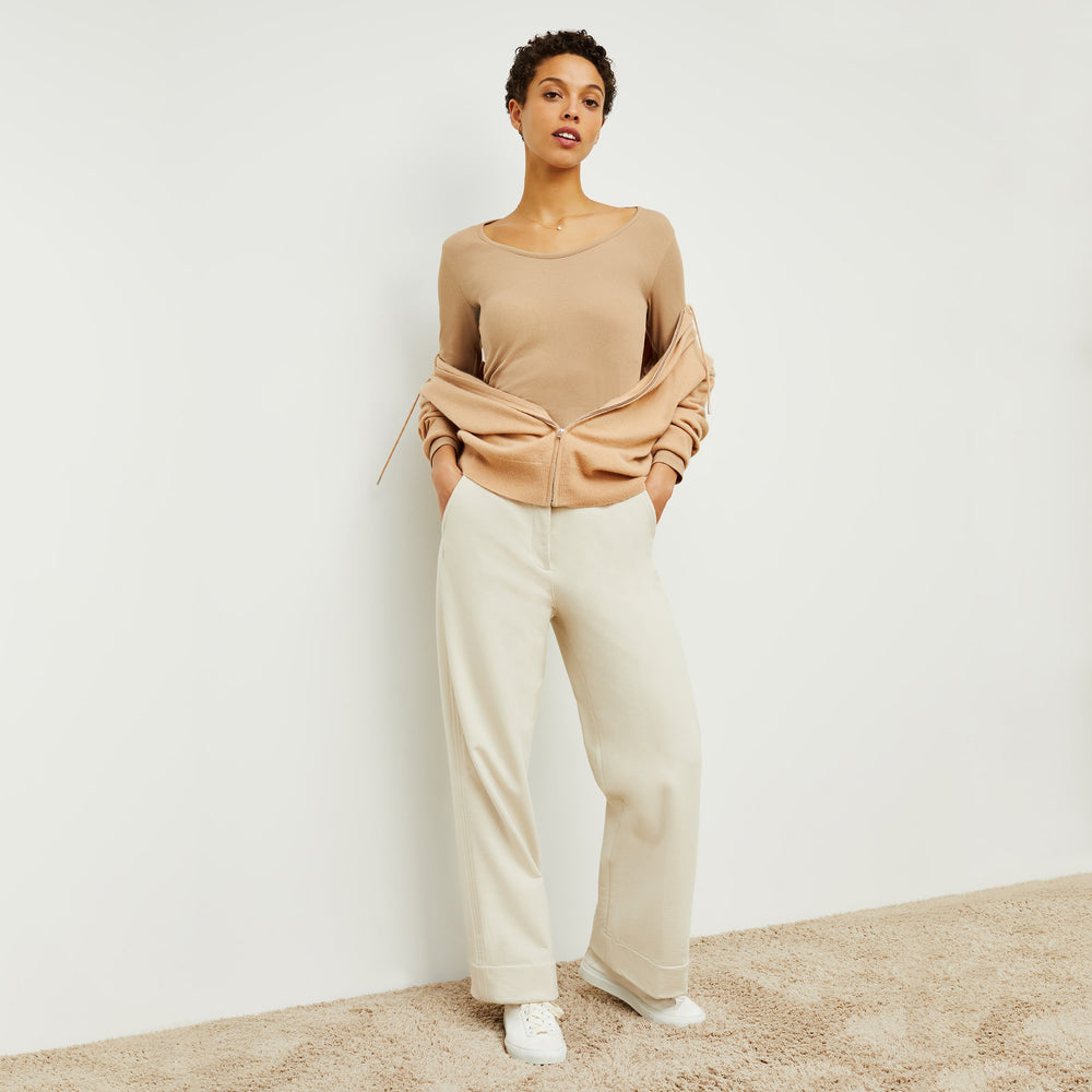 Front image of a woman standing wearing the marcia in camel