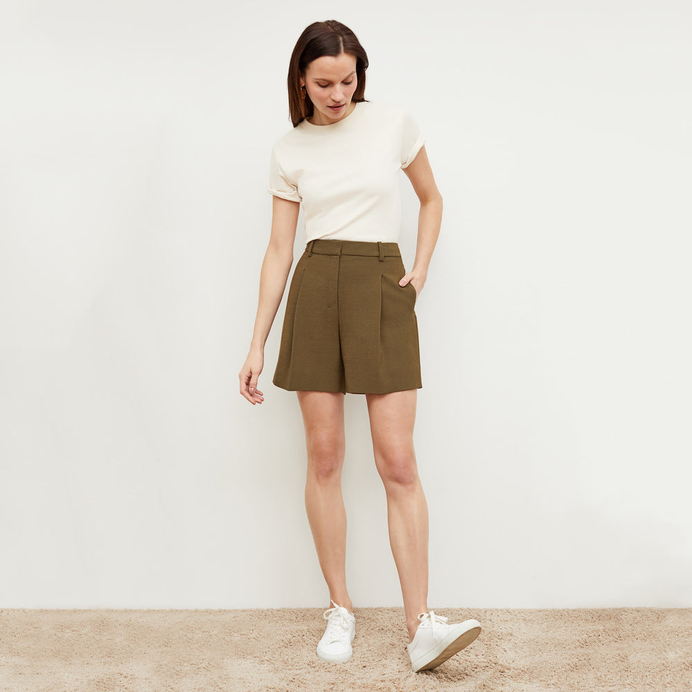 Front image of a woman standing wearing the Fletcher Short—Nep Suiting in Safari