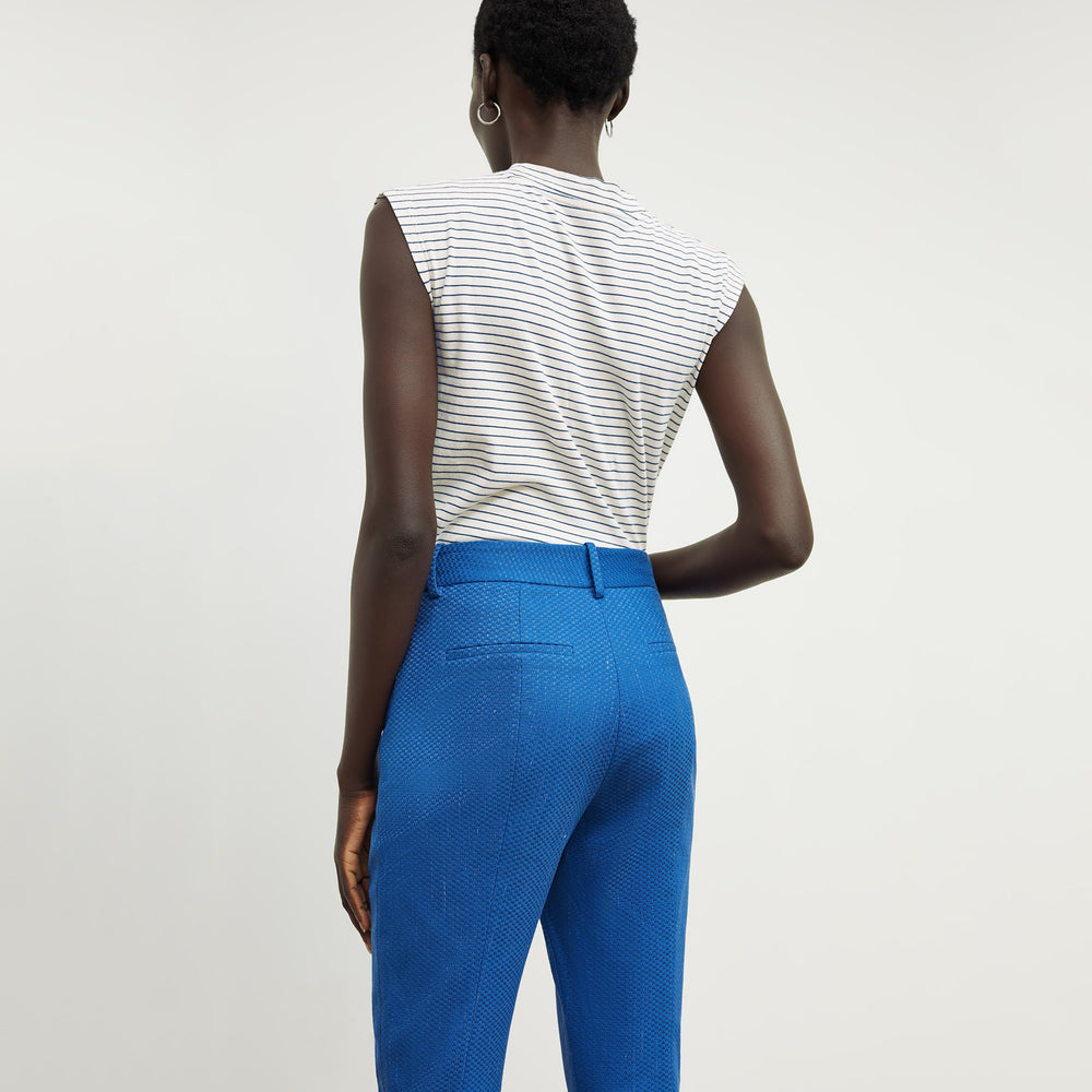 Back image of a woman standing wearing the condesa pant in basketweave jacquard in azure