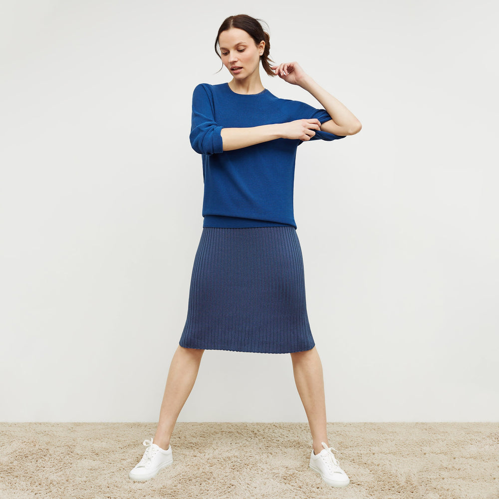 Front image of a woman standing wearing the dylan dress in adriatic blue