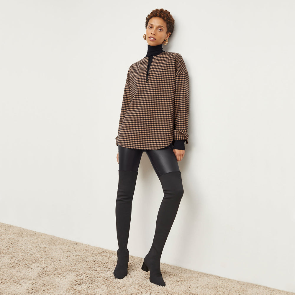 Front image of a woman wearing the nina boot in black
