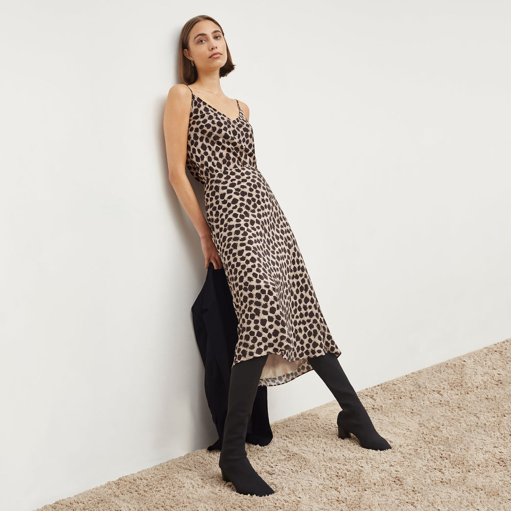 Front image of a woman standing wearing the Lisey Cami—Sahara Print Washable Silk in Tan/Black