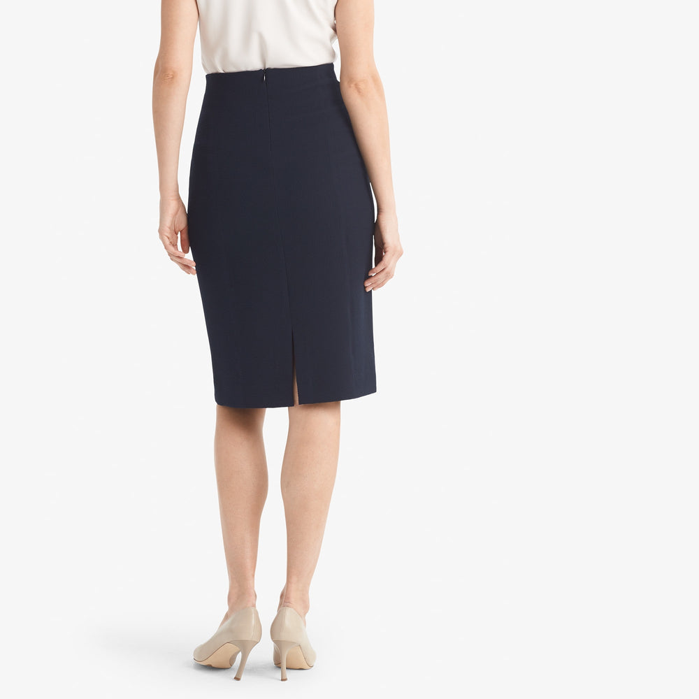 Back image of a woman standing wearing the Dorchester skirt staccato in galaxy blue