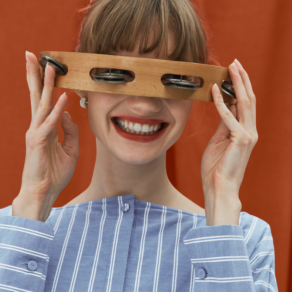 front image of a woman wearing the janie dress in poplin stripe