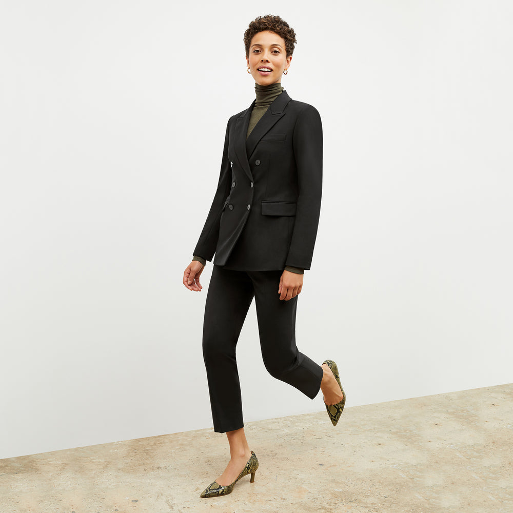 Front image of a woman wearing the smith pant in black