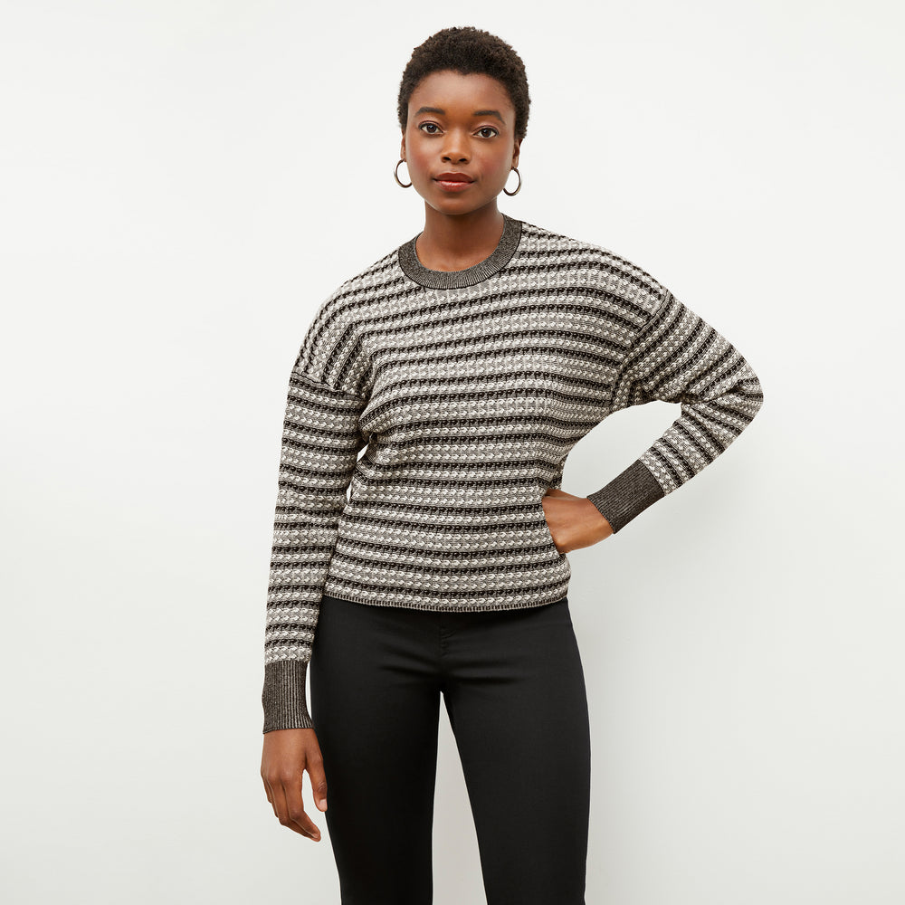 Front image of a woman wearing the tyler sweatshirt in black and white