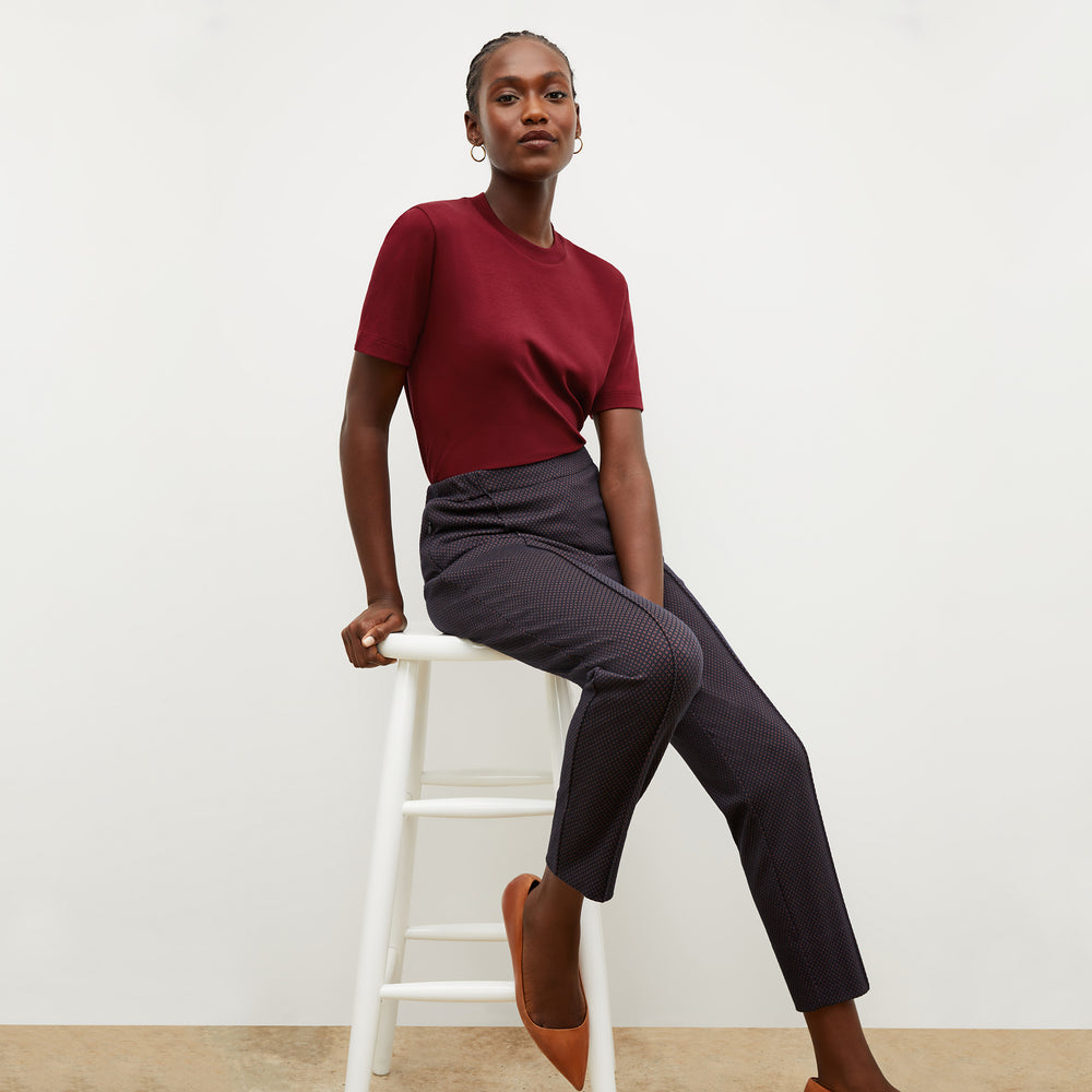 Front image of a woman wearing the leslie tshirt in maroon