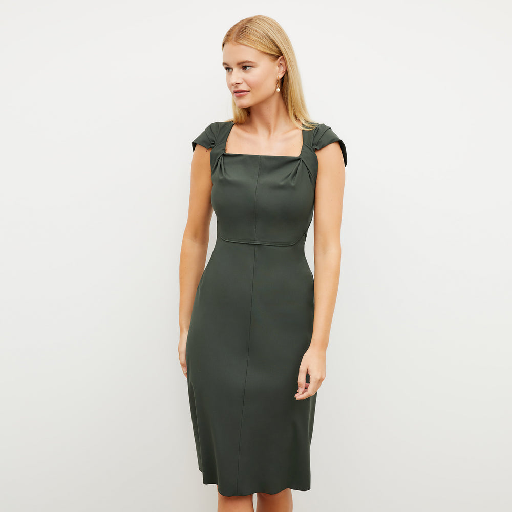 Image of a woman wearing the Charlene Dress in Dark Aloe