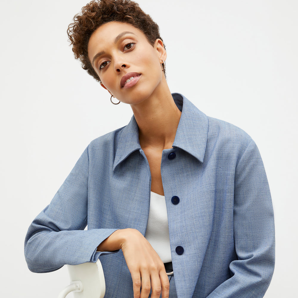 Front image of a woman wearing the nicky jacket in indigo and white