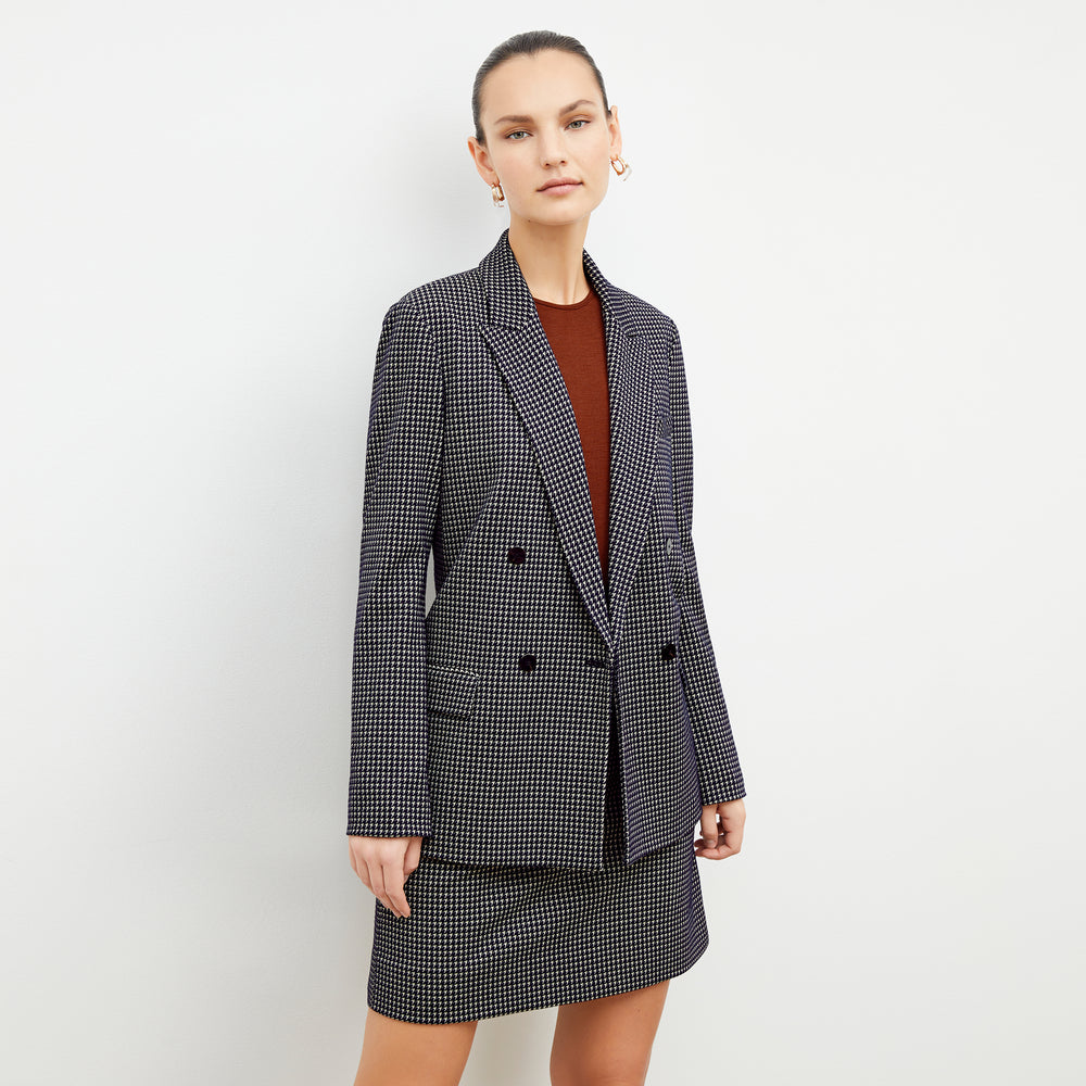 Front image of a woman wearing the whitney skirt in black and white