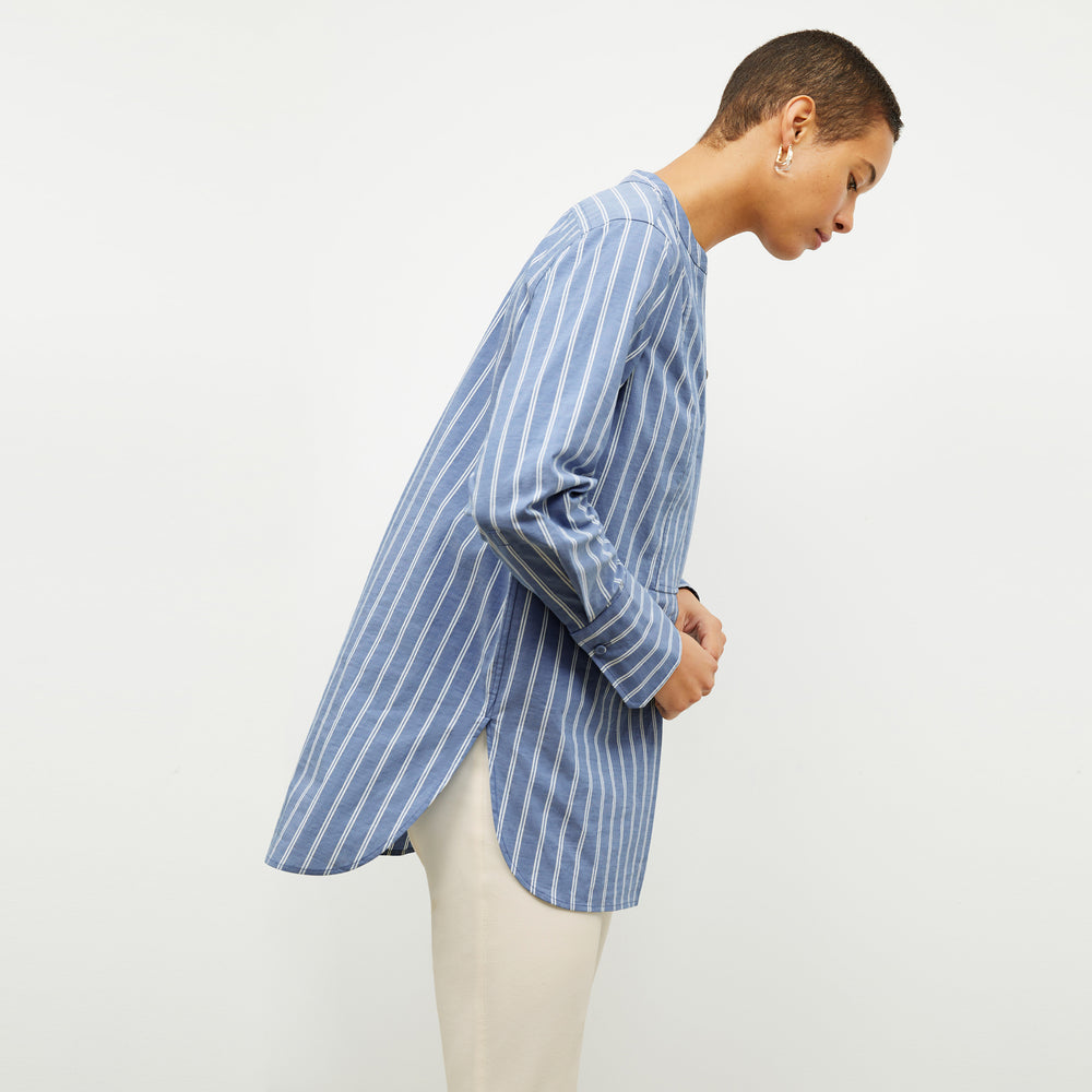 front image of a woman wearing the Nichols shirt in blue and white poplin stripe