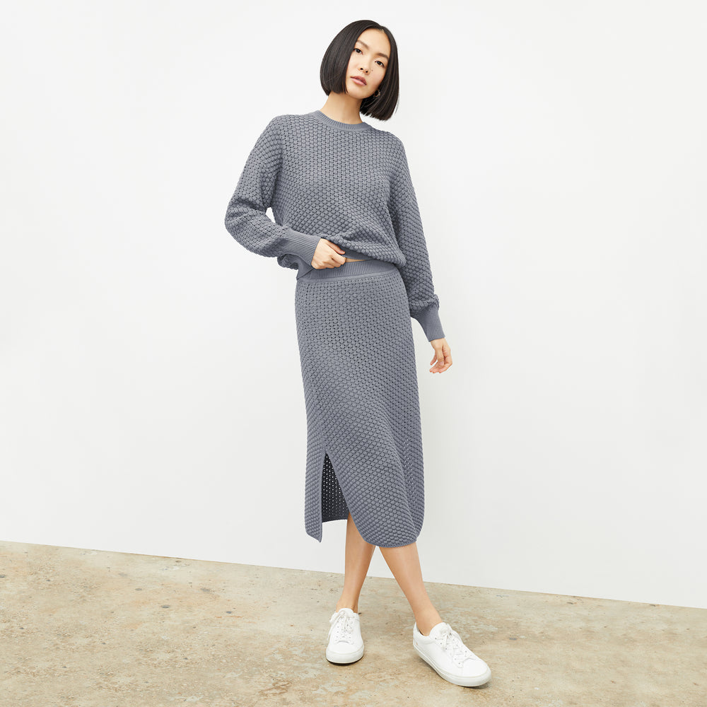 front image of a woman wearing the senga skirt in flint gray