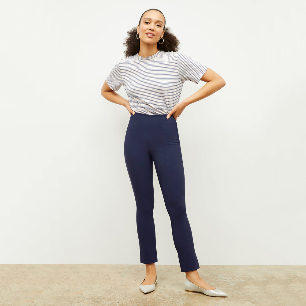 Front image of a woman standing wearing the Leslie T-Shirt—Thin Striped Cotton in Ivory / Coastline