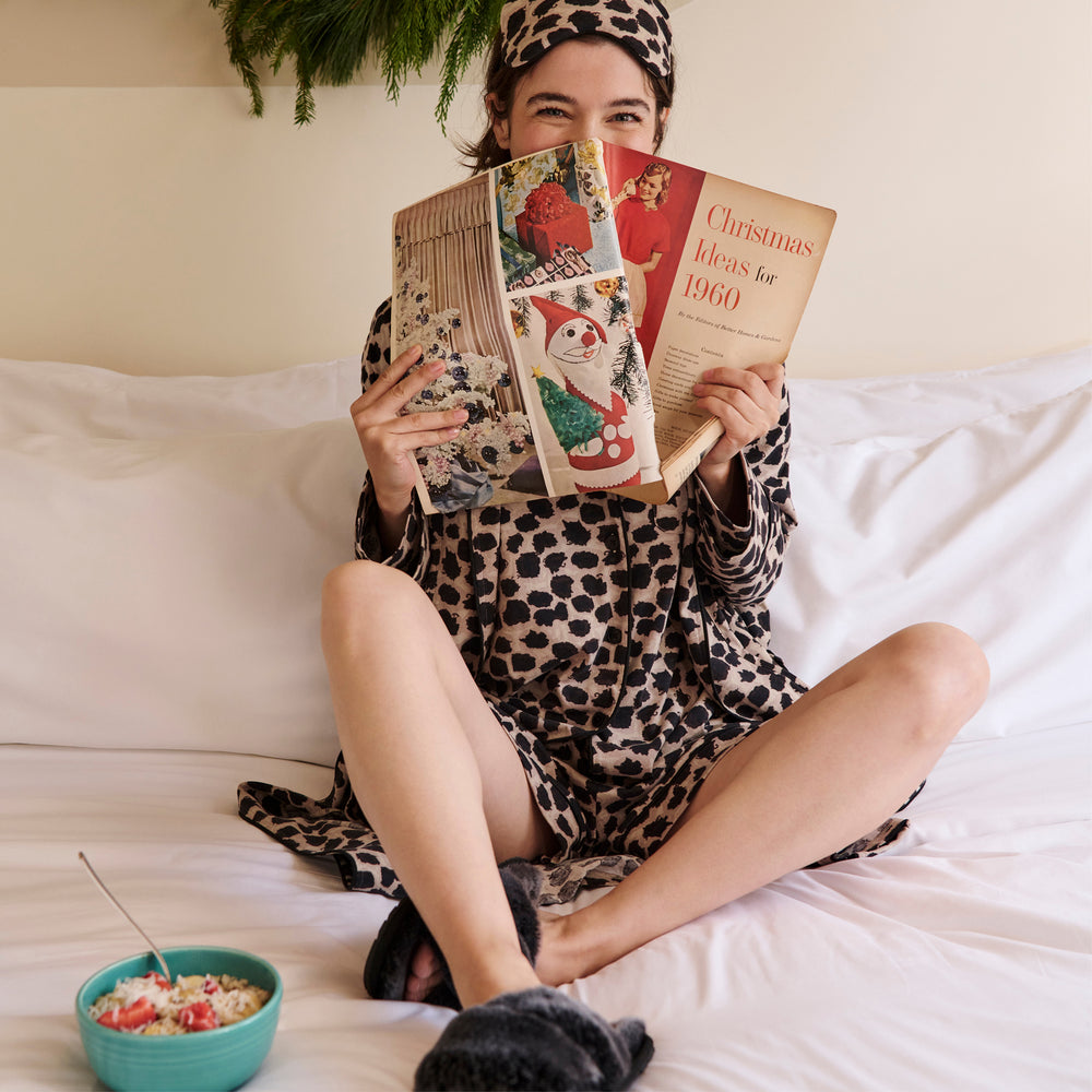 Front image of a woman wearing the Petite Plume x M.M. Luxe Pima Robe in Sahara Print