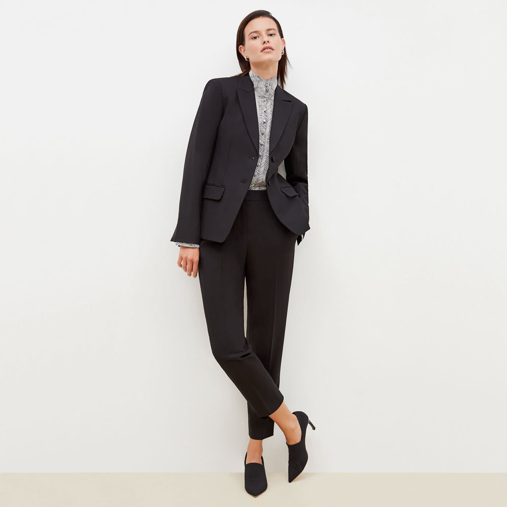 Front image of a woman standing wearing the bennett blazer wool twill in black