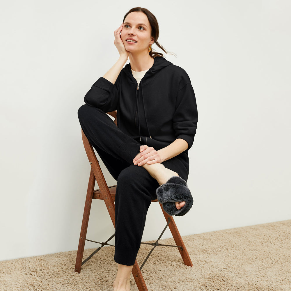 Front image of a woman standing wearing the Judith Hoodie—Cashmere in Black