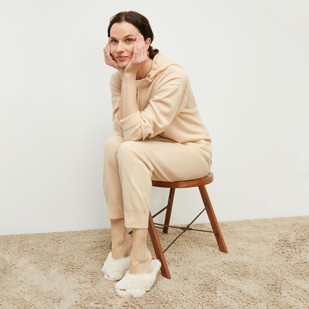 Side image of a woman standing wearing the Judith Hoodie—Cashmere in Turbinado