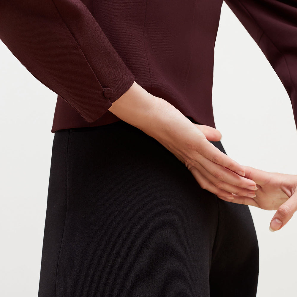 Detail image of a woman standing wearing the Dawn Top-Sharkskin in garnet