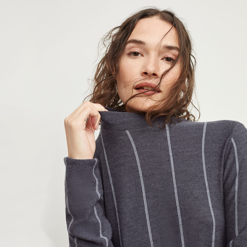 Detail image of a woman standing wearing the Effy Dress—Braided Stripe in Charcoal / Ivory