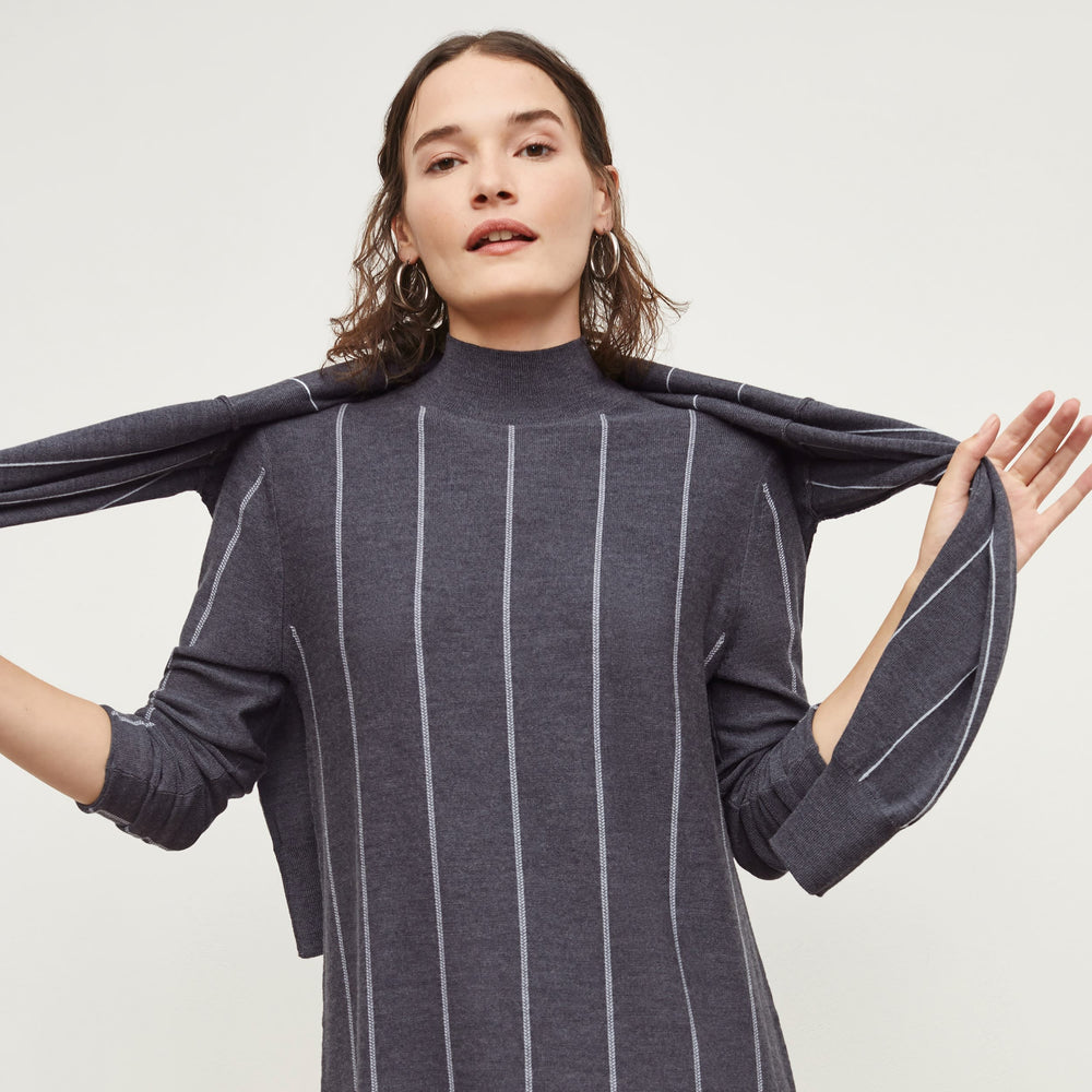 Front image of a woman standing wearing the Effy Dress—Braided Stripe in Charcoal / Ivory