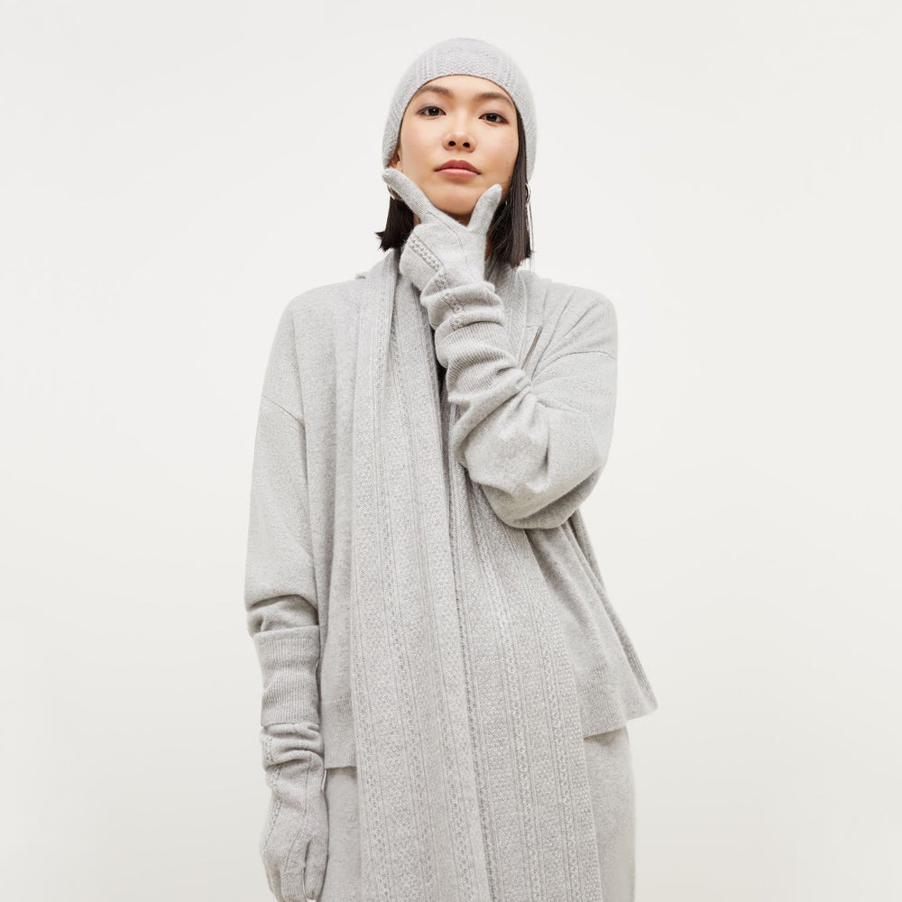 Front image of a woman standing wearing the Circle Cable Gloves—Cashmere in Heather Gray