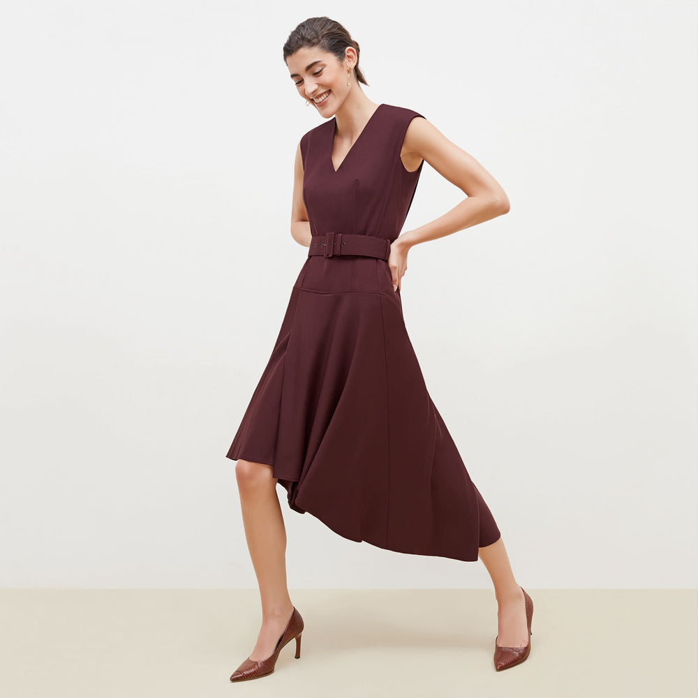 Side image of a woman standing wearing the Kelsey Dress-Sharkskin in garnet