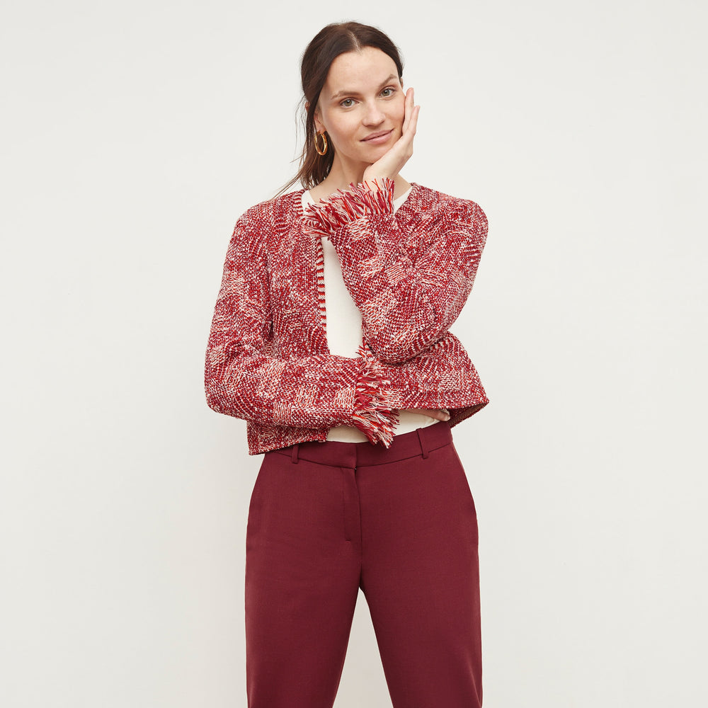 Front image of a woman standing wearing the Lilia Jacket—Interweave in Red Multi
