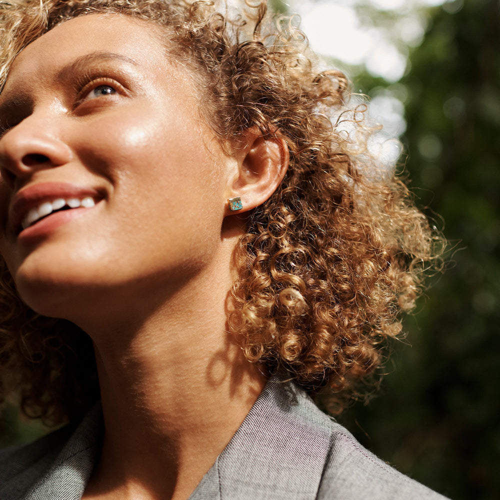 Front image of a woman standing wearing the Winona Earrings in Turquoise