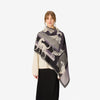 Image of a woman wearing a scarf with animals on it in black white and gray