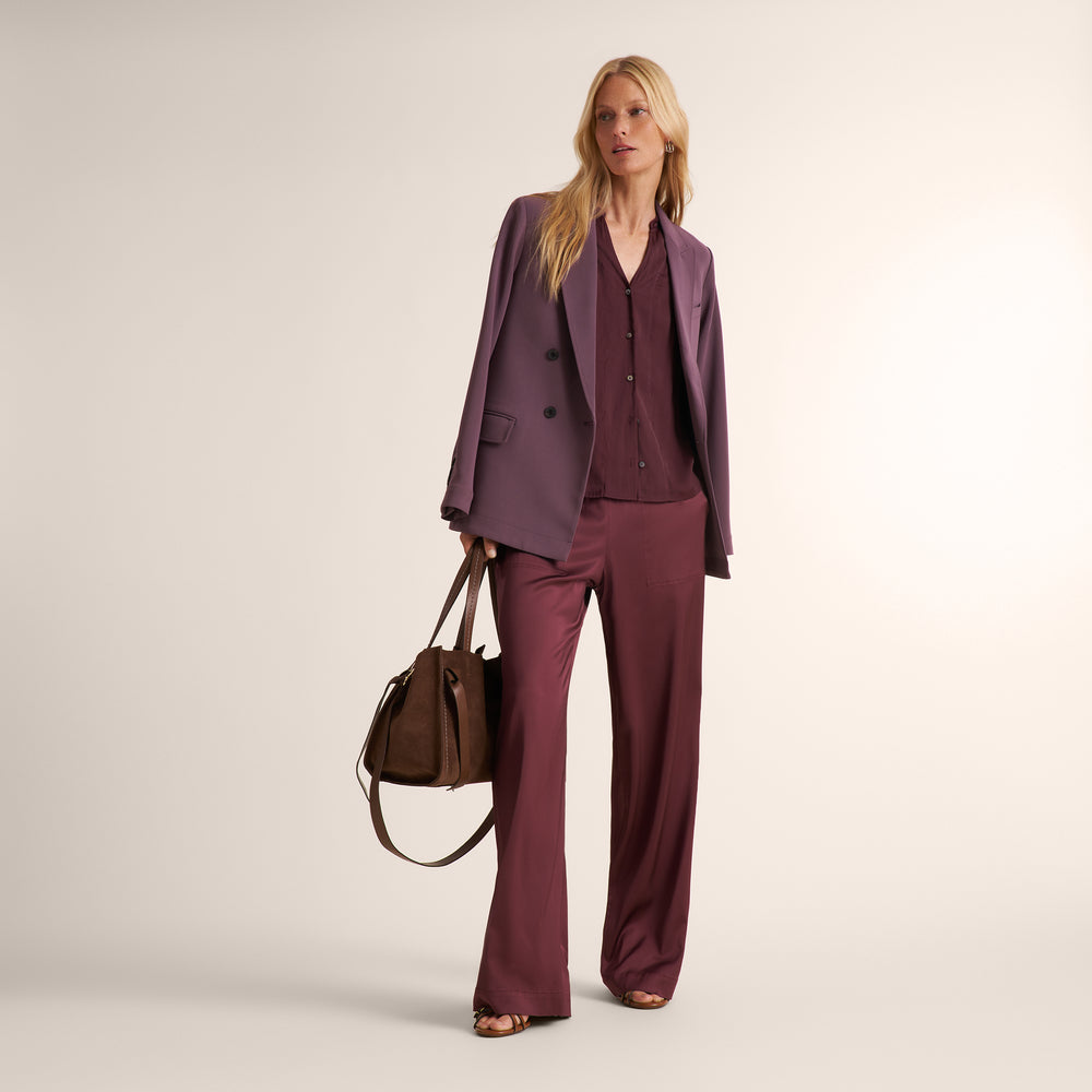 image of a woman holding a brown suede visona handbag