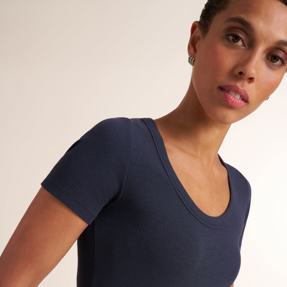 Woman wearing a scoop neck short sleeve navy t-shirt