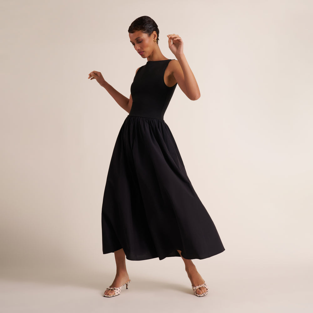 Woman wearing a sleeveless black maxi dress