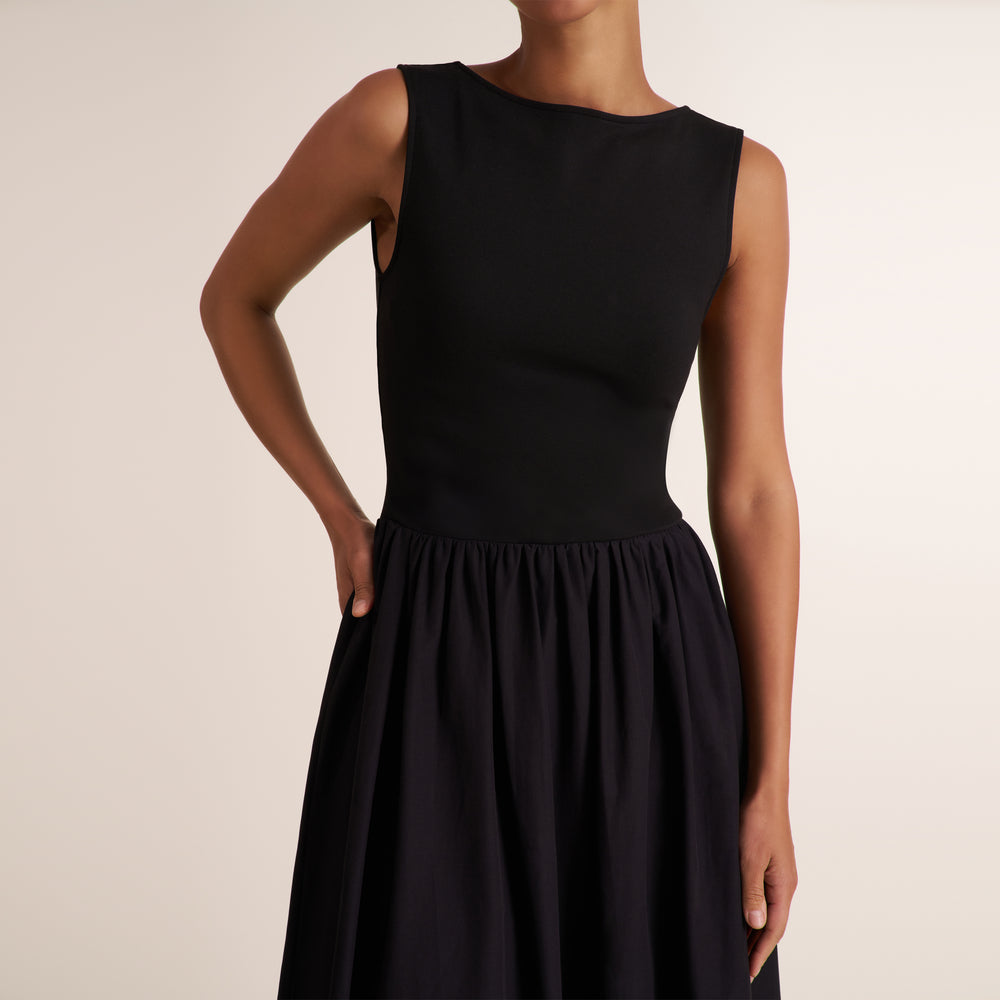 Woman wearing a sleeveless black maxi dress