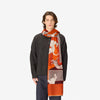 image of a man wearing the les cheris scarf in red