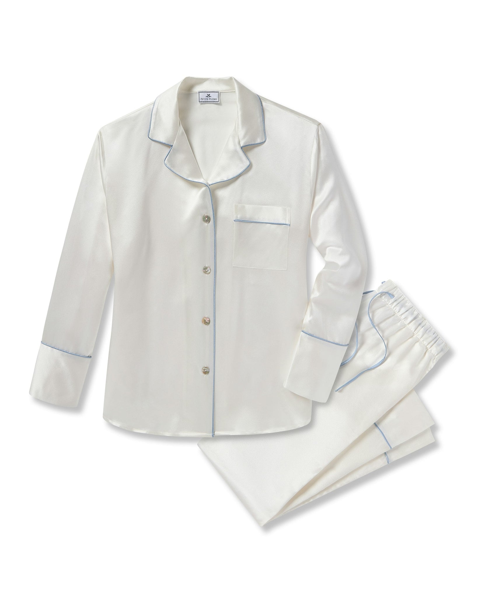 White satin pajama set with blue piping on a white background 