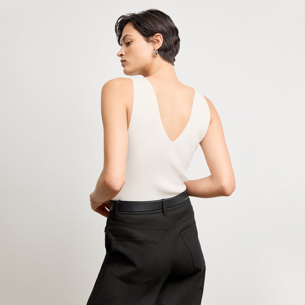 back image of a woman wearing the alecia top in ivory