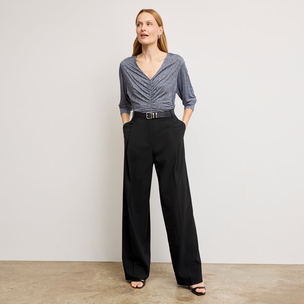 Front image of a woman wearing the amina top in blueprint sketch