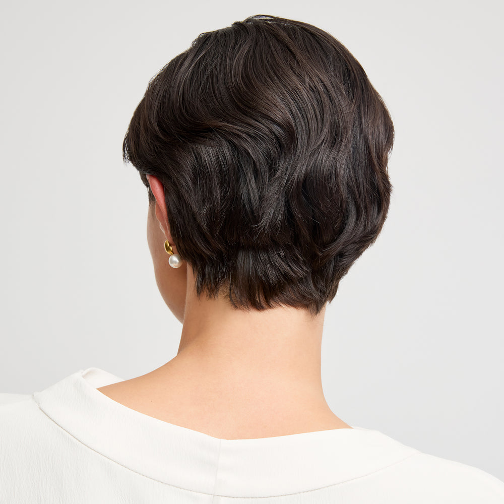detail image of a woman wearing the annmarie top in ivory