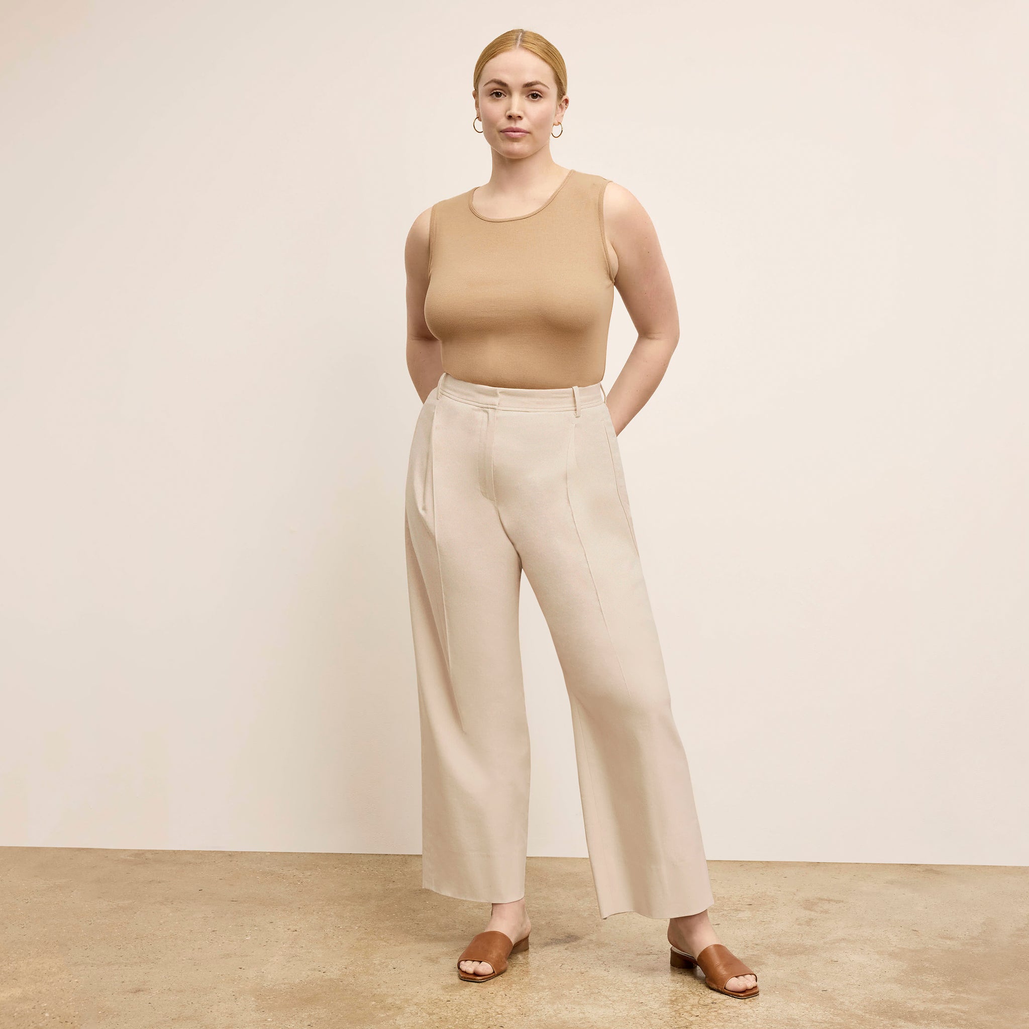 Front image of a woman standing wearing the Paige T-Shirt—Fine Ribbed Cotton in Camel