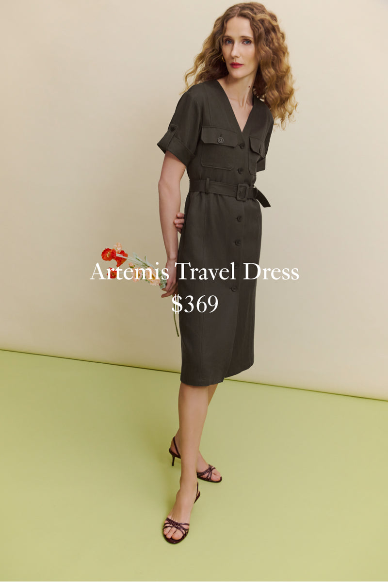 Woman wearing a dark green dress with a belt, standing against a light beige background.

ARTEMIS TRAVEL DRESS $369