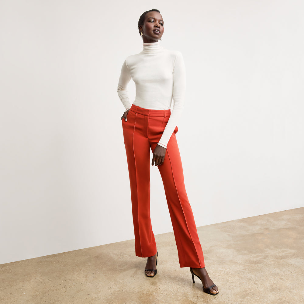 front image of a woman wearing the axam top in white