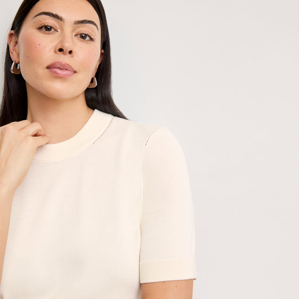 front image of a woman wearing the becca top in ivory