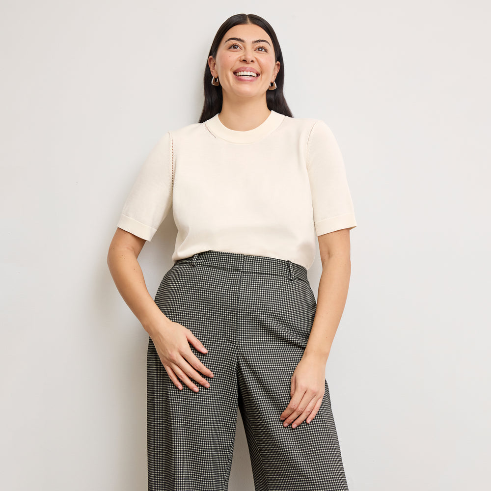 front image of a woman wearing the becca top in ivory