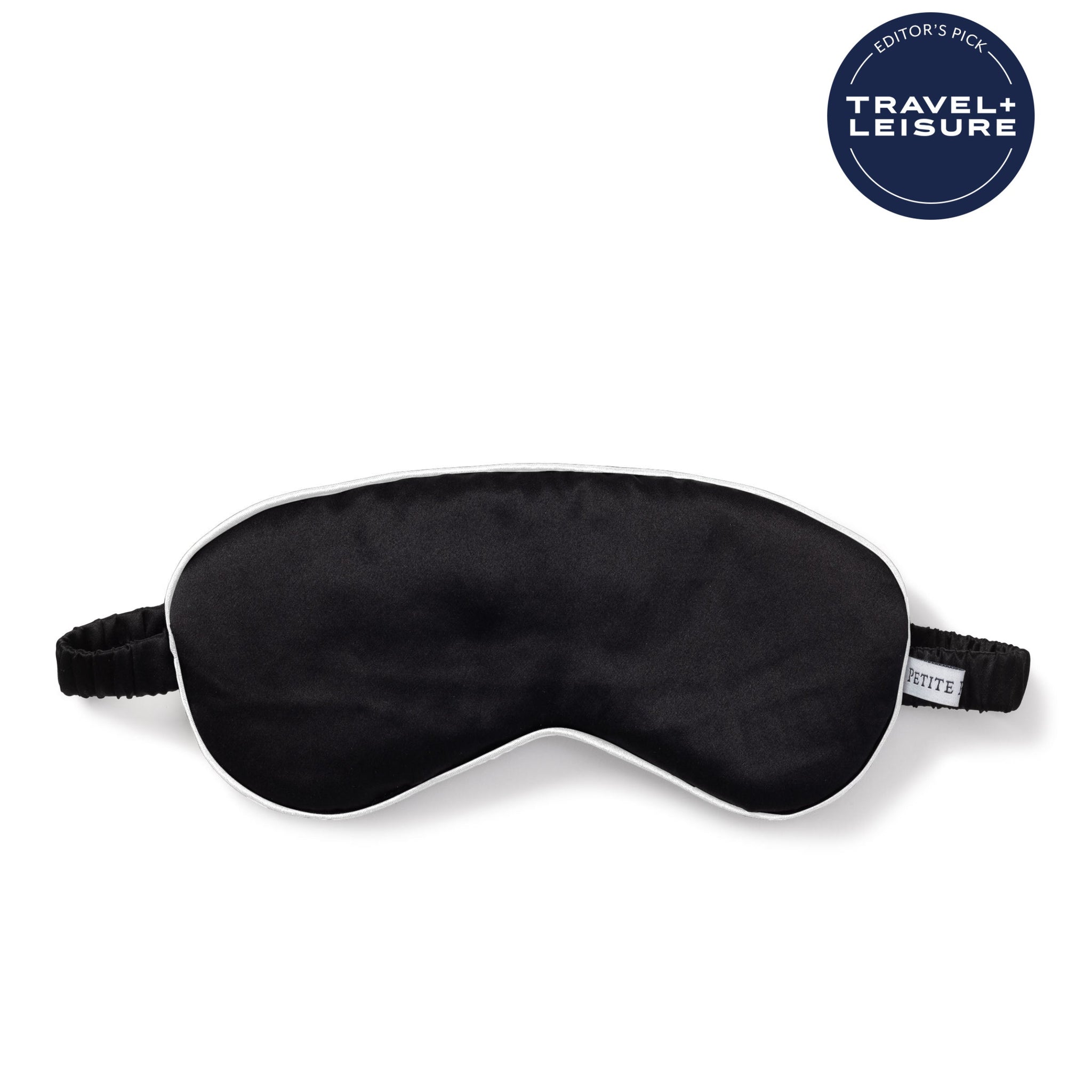 Black sleep mask on a white background with 'Travel + Leisure' logo. 