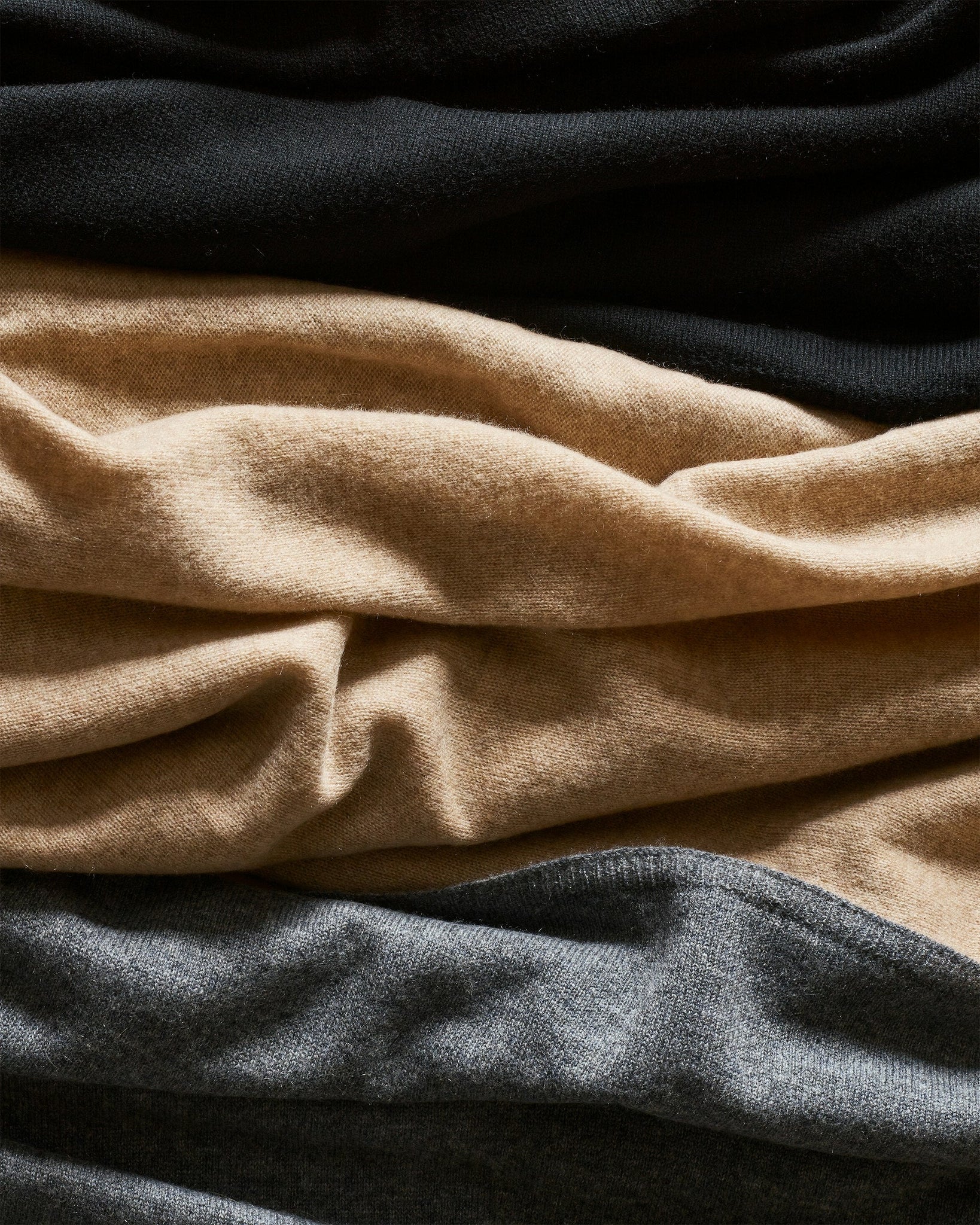Close-up of black, beige, and gray fabric swatches.