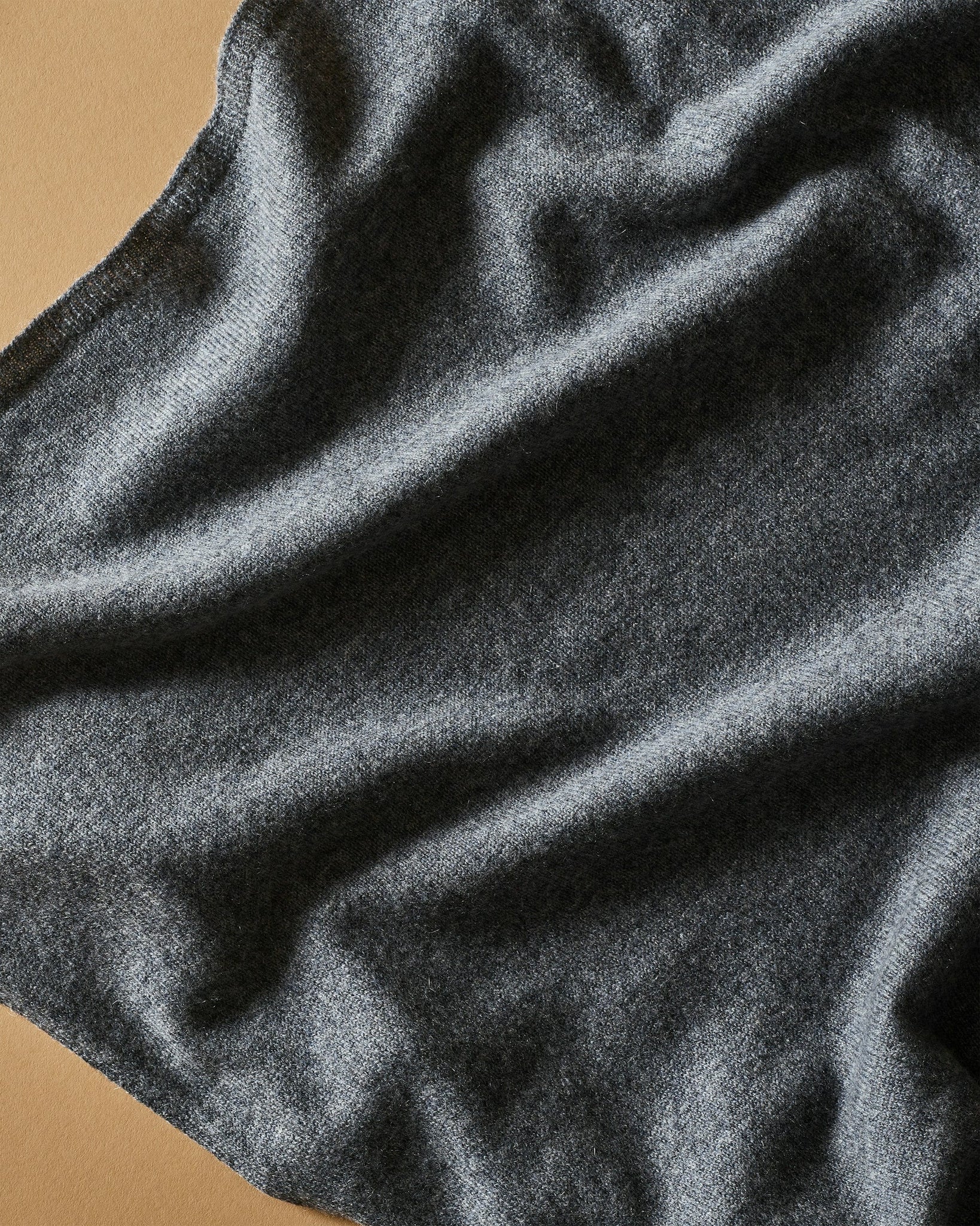 Close-up of dark gray fabric with a textured surface.